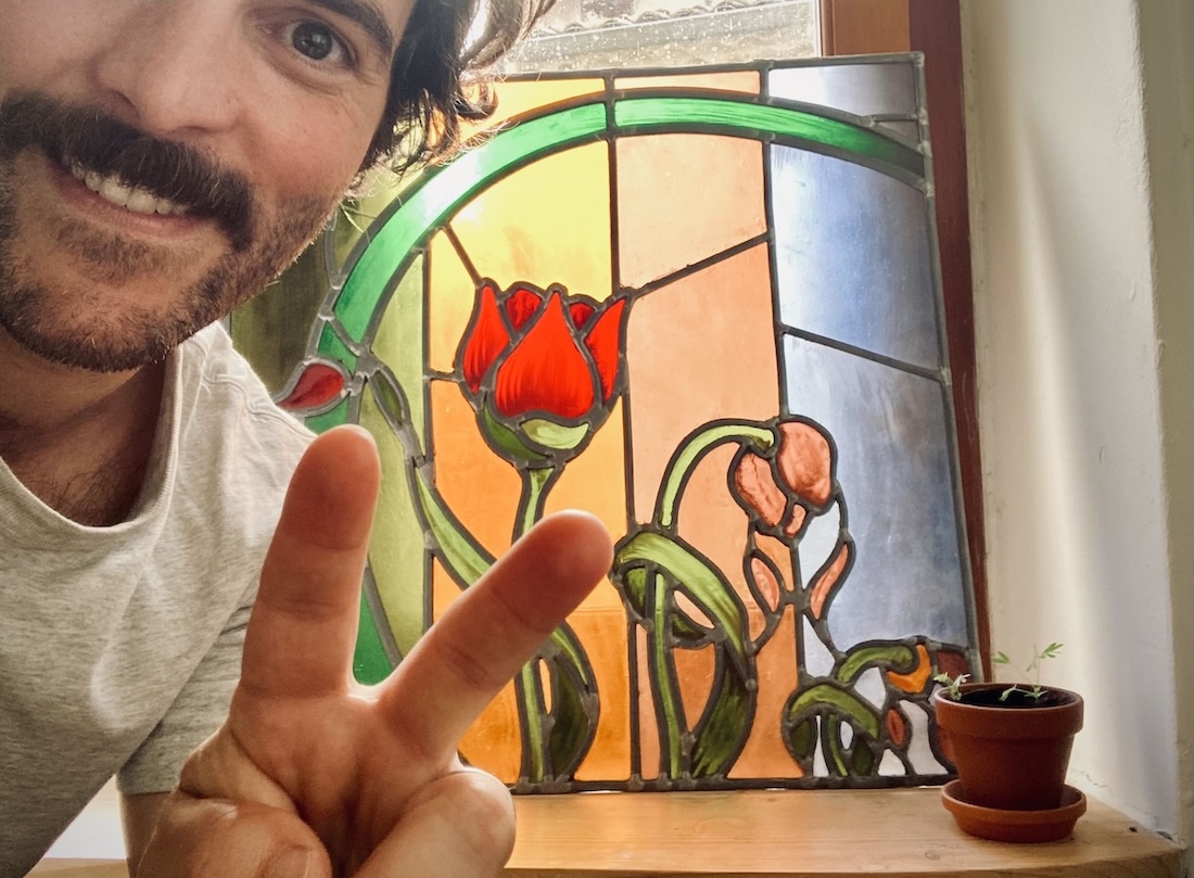 a picture of Remi Mercier in front of a stained glass